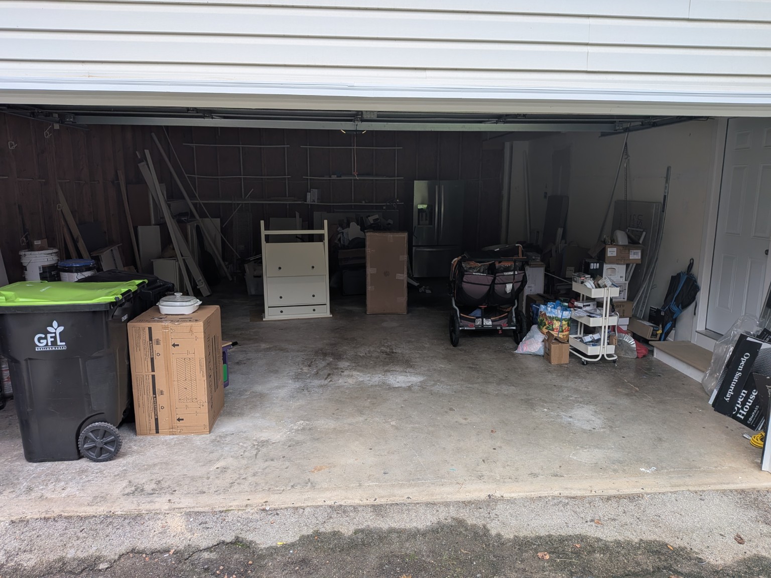 The same garage after removal, with open floor space and the customer's remaining belongings
