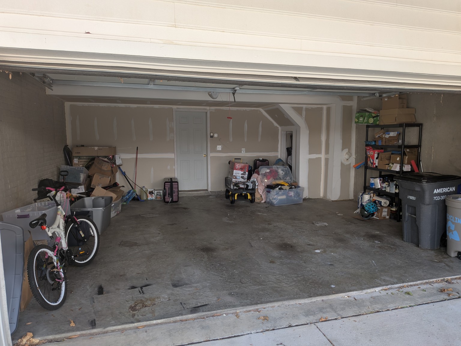 The same garage after removal, with open floor space and the customer's remaining belongings